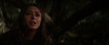 Movie still from “Southbound” (2015), directed by Tyler Gillett – A young woman is crying in a dark forest; Close Up shot, Over the shoulder angle