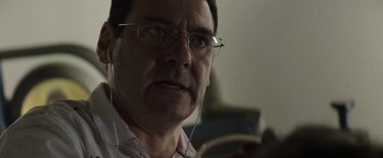 Movie still from “Southbound” (2015), directed by Tyler Gillett – A person wearing glasses and headphones; Close Up shot, Low angle