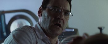 Movie still from “Southbound” (2015), directed by Tyler Gillett – A person wearing glasses and headphones; Close Up shot, Low angle