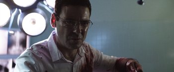 Movie still from “Southbound” (2015), directed by Tyler Gillett – A person wearing glasses with blood on them; Close Up shot, Low angle