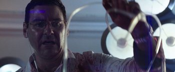 Movie still from “Southbound” (2015), directed by Tyler Gillett – A man in a white shirt is holding a microphone; Close Up shot, Low angle