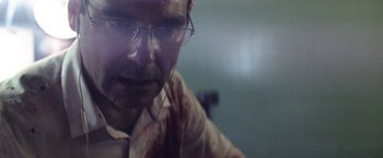 Movie still from “Southbound” (2015), directed by Tyler Gillett – A person wearing glasses with blood all over his face; Extreme Close Up shot, Low angle