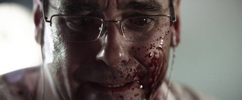 Movie still from “Southbound” (2015), directed by Tyler Gillett – A person with blood on his face; Extreme Close Up shot, Low angle