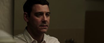 Movie still from “Southbound” (2015), directed by Tyler Gillett – A person wearing a shirt and tie; Close Up shot, Low angle