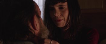 Movie still from “Southbound” (2015), directed by Tyler Gillett – A woman looking at a man's face in a dark room; Close Up shot, Over the shoulder angle