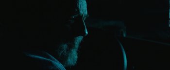 Movie still from “Southbound” (2015), directed by Tyler Gillett – A man with a long white beard looking into the distance; Close Up shot, Over the shoulder angle
