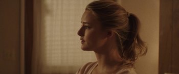 Movie still from “Southbound” (2015), directed by Tyler Gillett – A beautiful blonde woman looking off to her right; Close Up shot, Over the shoulder angle