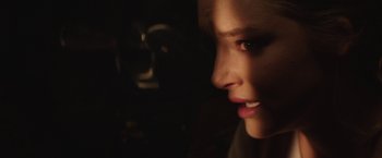 Movie still from “Southbound” (2015), directed by Tyler Gillett – A woman's face in the dark; Extreme Close Up shot, Over the shoulder angle