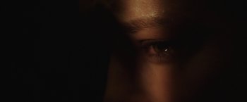 Movie still from “Southbound” (2015), directed by Tyler Gillett – A person's eye in the dark; Extreme Close Up shot, Overhead angle