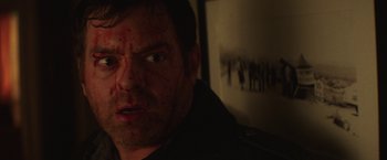 Movie still from “Southbound” (2015), directed by Tyler Gillett – A person with blood all over his face; Close Up shot, High angle
