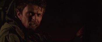 Movie still from “Southbound” (2015), directed by Tyler Gillett – A person in a dark room; Close Up shot, Over the shoulder angle