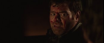 Movie still from “Southbound” (2015), directed by Tyler Gillett – A person with blood all over his face; Close Up shot, Over the shoulder angle