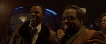 Movie still from “Sparkle” (2012), directed by Salim Akil – Two men and a woman smiling for the camera; Close Up shot, Low angle