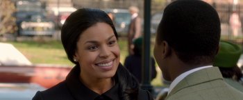 Movie still from “Sparkle” (2012), directed by Salim Akil – A woman smiles at the camera as she talks to a man; Close Up shot, Over the shoulder angle
