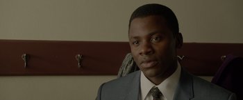 Movie still from “Sparkle” (2012), directed by Salim Akil – A person wearing a suit and tie; Close Up shot, Low angle