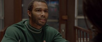 Movie still from “Sparkle” (2012), directed by Salim Akil – A person sitting at a table; Close Up shot, Over the shoulder angle