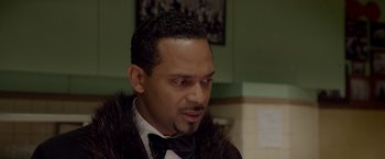 Movie still from “Sparkle” (2012), directed by Salim Akil – A person wearing a bow tie; Close Up shot, Over the shoulder angle