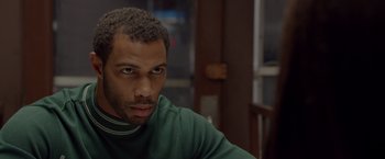 Movie still from “Sparkle” (2012), directed by Salim Akil – A person wearing a green shirt; Close Up shot, Over the shoulder angle