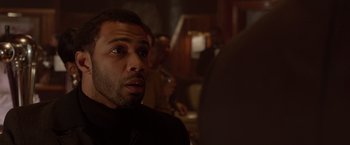 Movie still from “Sparkle” (2012), directed by Salim Akil – A person wearing a suit and tie; Close Up shot, Over the shoulder angle