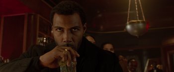 Movie still from “Sparkle” (2012), directed by Salim Akil – A person holding a glass of beer; Close Up shot, Over the shoulder angle