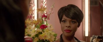 Movie still from “Sparkle” (2012), directed by Salim Akil – A person near a vase of flowers; Close Up shot, Over the shoulder angle