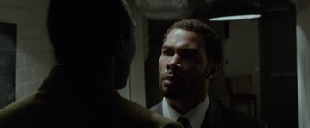 Movie still from “Sparkle” (2012), directed by Salim Akil – A man wearing a suit and tie talking to another man in front of a mirror; Close Up shot, Over the shoulder angle