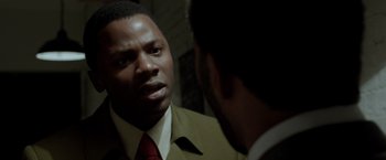 Movie still from “Sparkle” (2012), directed by Salim Akil – A man wearing a suit talking to another man in front of a mirror; Close Up shot, Over the shoulder angle