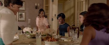 Movie still from “Sparkle” (2012), directed by Salim Akil – Two women sitting at a table with a plate of food on it; Medium shot, High angle