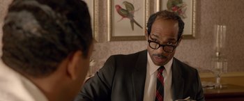 Movie still from “Sparkle” (2012), directed by Salim Akil – A man wearing a suit and tie talking to another man; Close Up shot, Over the shoulder angle