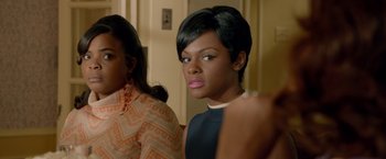 Movie still from “Sparkle” (2012), directed by Salim Akil – A woman with short black hair is looking at the camera; Close Up shot, Over the shoulder angle
