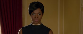 Movie still from “Sparkle” (2012), directed by Salim Akil – A woman with short black hair wearing a black top; Close Up shot, Over the shoulder angle
