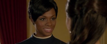 Movie still from “Sparkle” (2012), directed by Salim Akil – A woman is smiling at the camera while looking at her reflection; Close Up shot, Over the shoulder angle