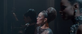 Movie still from “Sparkle” (2012), directed by Salim Akil – A woman in a black dress with a high bun; Medium shot, Over the shoulder angle