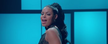 Movie still from “Sparkle” (2012), directed by Salim Akil – A woman with long black hair is singing; Close Up shot, Low angle