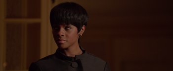 Movie still from “Sparkle” (2012), directed by Salim Akil – A woman with short black hair wearing a black jacket; Close Up shot, Over the shoulder angle