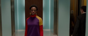 Movie still from “Sparkle” (2012), directed by Salim Akil – A woman standing in front of an elevator in a room; Medium shot, Over the shoulder angle