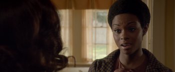 Movie still from “Sparkle” (2012), directed by Salim Akil – A woman in a checkered jacket is looking at a mirror; Close Up shot, Over the shoulder angle