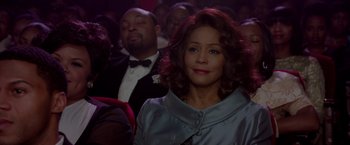Movie still from “Sparkle” (2012), directed by Salim Akil – A woman is sitting in a crowd of people; Close Up shot, Over the shoulder angle