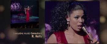 Movie still from “Sparkle” (2012), directed by Salim Akil – A woman in a red dress is on a stage; Close Up shot, Overhead angle