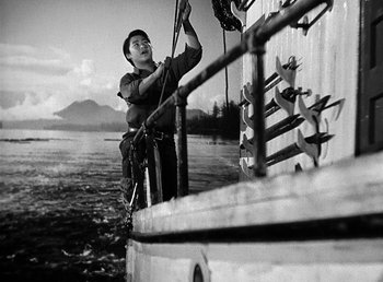 Movie still from “Spawn of the North” (1938), directed by Henry Hathaway – A person on a boat in the water with a rope; Medium shot, Low angle