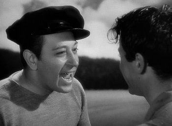 Movie still from “Spawn of the North” (1938), directed by Henry Hathaway – Two young men talking to each other in a field; Close Up shot, Over the shoulder angle