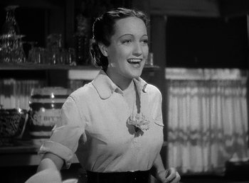 Movie still from “Spawn of the North” (1938), directed by Henry Hathaway – A black - and - white photo of a woman smiling; Medium shot, Low angle