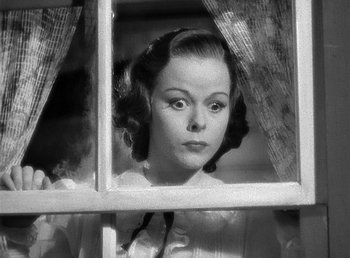 Movie still from “Spawn of the North” (1938), directed by Henry Hathaway – A black - and - white photo of a woman looking out of a window; Close Up shot, Low angle