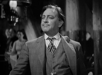 Movie still from “Spawn of the North” (1938), directed by Henry Hathaway – A black and white photo of a man in a suit and tie; Close Up shot, Low angle