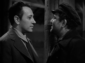 Movie still from “Spawn of the North” (1938), directed by Henry Hathaway – Two men are facing each other and one has his mouth wide open; Close Up shot, Over the shoulder angle