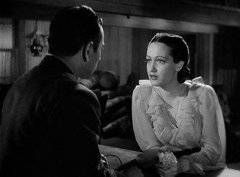 Movie still from “Spawn of the North” (1938), directed by Henry Hathaway – A man and a woman sitting at a table talking to each other; Close Up shot, Over the shoulder angle