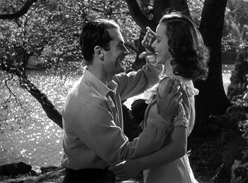 Movie still from “Spawn of the North” (1938), directed by Henry Hathaway – A man and a woman dancing in front of a tree; Medium shot, High angle