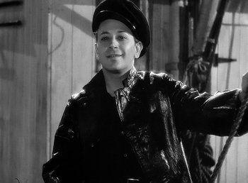 Movie still from “Spawn of the North” (1938), directed by Henry Hathaway – A young man wearing a leather jacket and a hat; Medium shot, High angle
