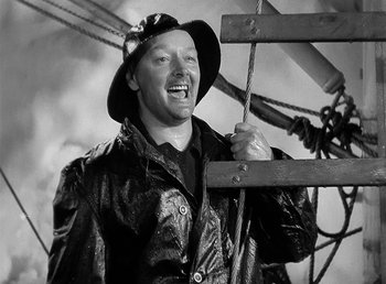 Movie still from “Spawn of the North” (1938), directed by Henry Hathaway – A man wearing a leather jacket and a hat; Medium shot, High angle