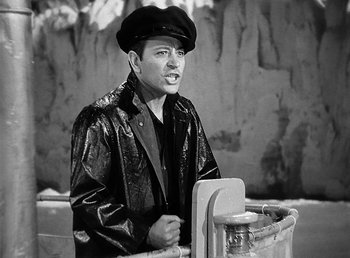 Movie still from “Spawn of the North” (1938), directed by Henry Hathaway – A man wearing a leather jacket and a hat; Medium shot, High angle